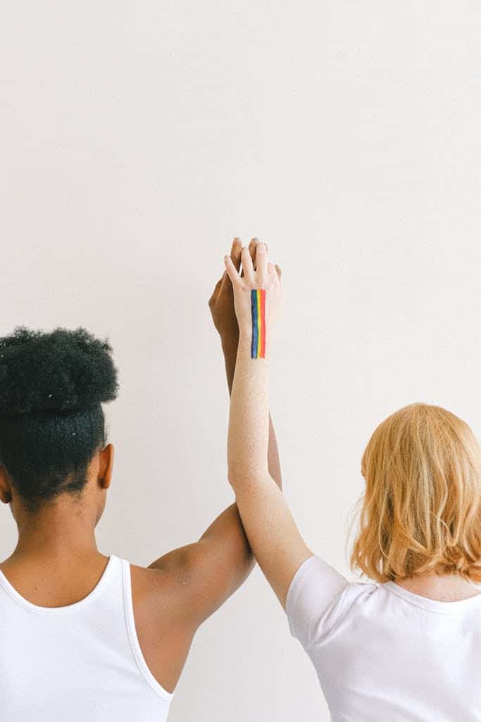 1757717898_an-interracial-couple-showing-unity-and-pride-with-raised-arms-and-a-rainbow-tattoo.-4557817-683x1024