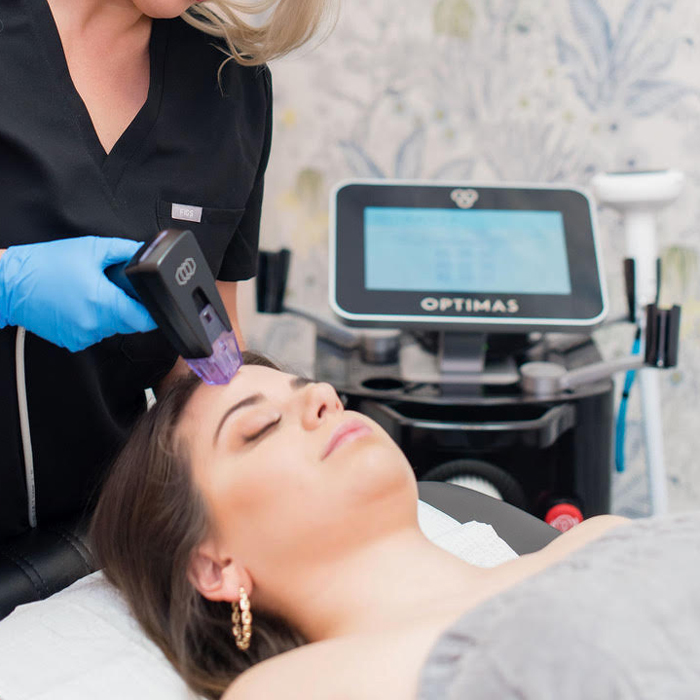 medical aesthetician using the Morpheus9 RF microneedling machine on client